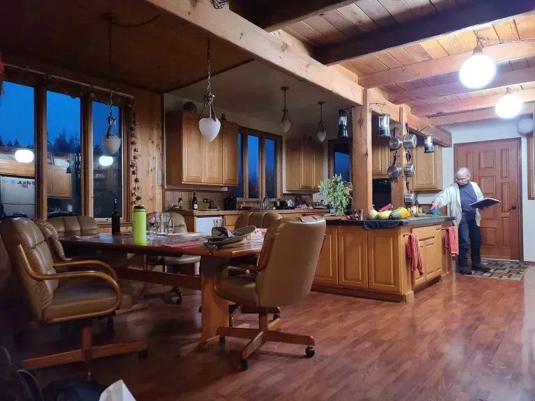 A view of the kitchen and dining room in the main cabin. Jim's favorite chair pictured farthest.